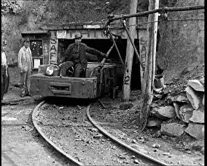 Towing: Small Train Towing Coal Wagons Coming Out of a Mine