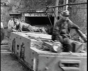 Towing: Small Train Towing Coal Wagons Coming Out of a Mine