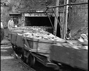 Towing: Small Train Towing Coal Wagons Coming Out of a Mine
