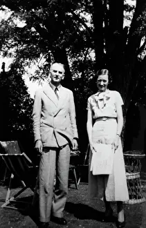 Deckchairs: Smart English pair standing in a garden
