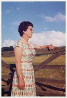 Tom Gillmor: Smartly-dressed middle aged woman leaning on a gate