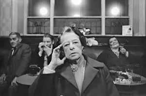 Smartly: Smartly dressed old lady in pub with friends behind