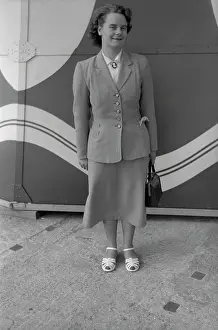 Nigel Sorrell: Smartly-dressed young lady in front of a patterned backdrop