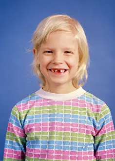Lovable: Smiling Blond Girl Missing her Front Teeth Looking