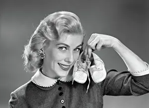 Booties: Smiling blond woman communicating that she is