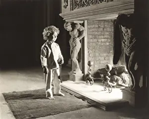 Ov1607: Smiling boy in front of fireplace holding Christmas stocking