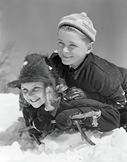 Cardiovascular: Smiling Boy and Girl Sledding
