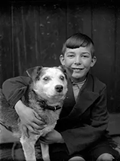 A smiling boy and his terrier dog