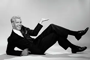 Businesspeople: Smiling businessman reclining propped on elbow