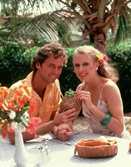 Straws: Smiling Couple Drinking Cocktail out of a Pineapple Sha