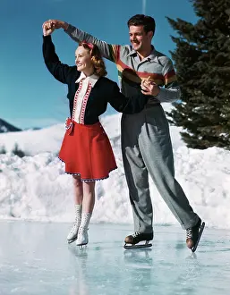 Smiling Couple Ice Skating Doing A Twirl