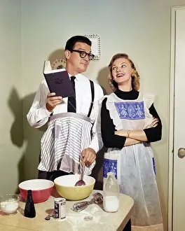 Homemaker: Smiling Couple in Kitchen with Husband Learning