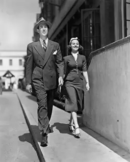 Sidewalks: Smiling couple walking on sidewalk