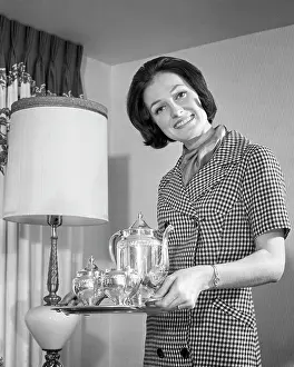 Homemaker: Smiling Dark Haired Woman Hostess Looking at Camera