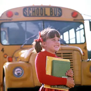 K 12: Smiling Elementary School Girl Standing Front of Bus Carry