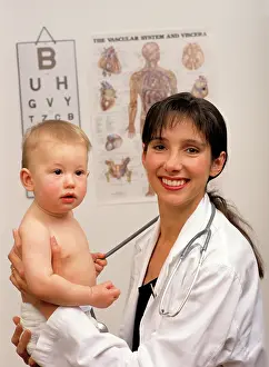 Diaper: Smiling Female Pediatrician looking at Camera Holding Bab