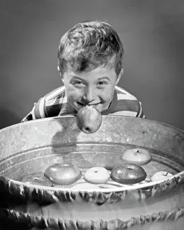 Freckled: Smiling Freckle Faced Boy Bobbing for Apples