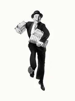Aerobic: Smiling Happycamera Carrying Arms Full of Packages Presents