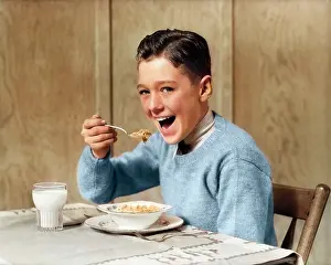 Preteen: Smiling Hungry Boy Looking at Camera Eating Breakfast