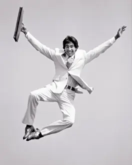Ecstatic: Smiling Man Businessman Looking at Camera Jumping