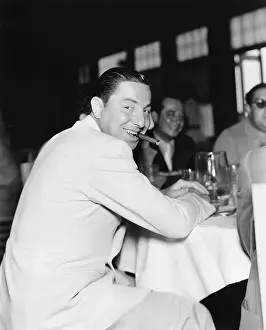 Grouping: Smiling man with a cigar in his mouth in a restaurant