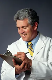 Bar007: SMILING MAN DOCTOR WRITING ON CLIPBOARD CHART