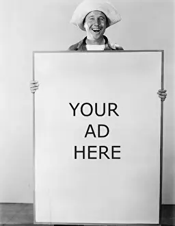 Expressive: Smiling man holding sign