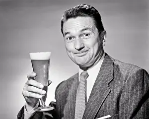 Pilsner: Smiling Man in Jacket and Tie Looking at Camera Hand