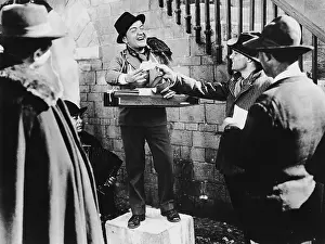 Salesmen: Smiling man taking bets in the street