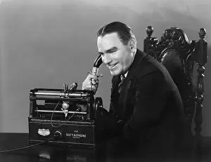 Professionals: Smiling man using Dictaphone