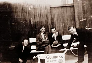 Stout: Four smiling men with Guinness advert
