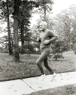Jogger: Smiling Middle Aged Man Jogging Running on Autumn