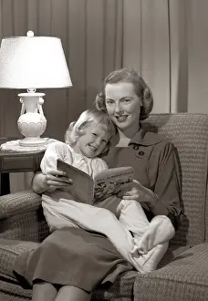 Egx001: Smiling Mother And Daughter Reading