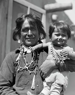 Cochiti: Smiling Native American Man Looking at Camera Holding His