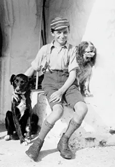 Barnabys: A smiling schoolboy and his two dogs