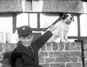 A smiling schoolboy and his terrier dog