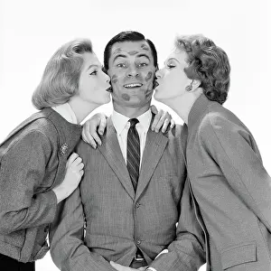 Crr001: Smiling Single Man Looking at Camera Being Kissed by Tw