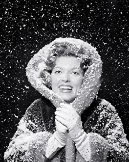 Deb001: Smiling Woman in Falling Snow Storm Looking at