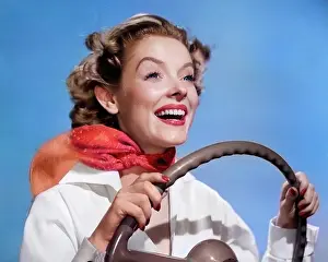 Deb001: Smiling Woman with Hands on Steering Wheel with