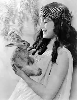 Petting: Smiling woman with pet rabbit