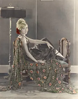 Classy: Smiling woman sitting on divan