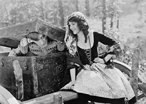 Cautious: Smiling woman with soldier emerging from trunk