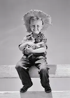 C1968: Smiling Young Farm Boy Looking at Camera Sitting