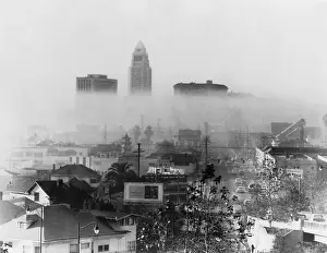 Obscures: Smog obscures view of downtown high-rises, ?