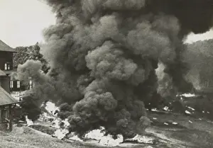 Lcgr1407: Smoke rises from a rubber factory destroyed by the