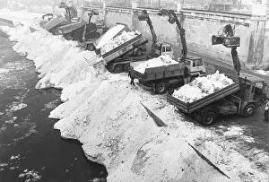 Dumped: Snow is dumped by trucks into Danube Canal