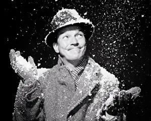 Bundled: Snow Falling at Night on Smiling Man Bundled up