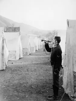 Bugles: Soldier blowing bugle in army camp