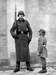 Propagandistic: Soldier and child in uniform, 1939