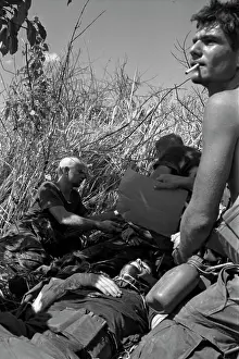Stocktrek Images: Soldier fans a mortally wounded comrade in the